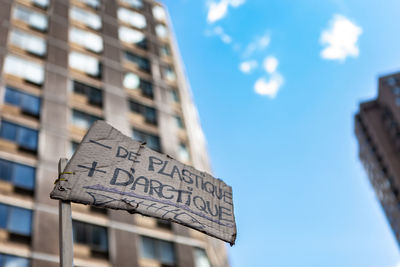 Low angle view of text on building against sky