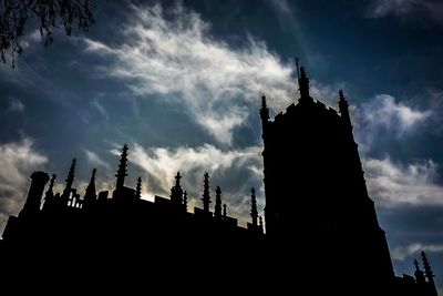 Low angle view of silhouette trees against sky