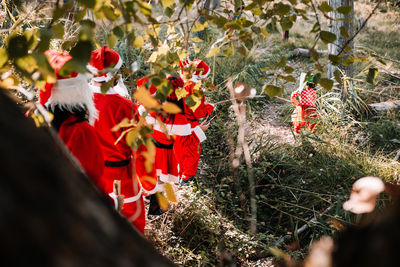 People wearing costumes while walking in forest