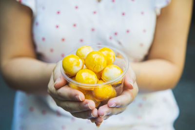 Asian woman hands holding a cup of sweet filling with salted egg