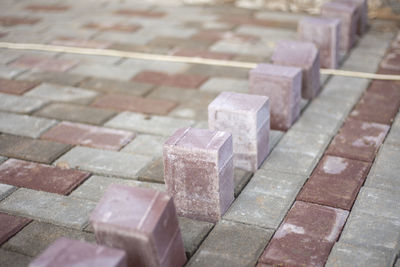 Laying tiles on street. stone blocks for road. construction works in city. 