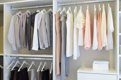 Clothes hanging in cabinet at home