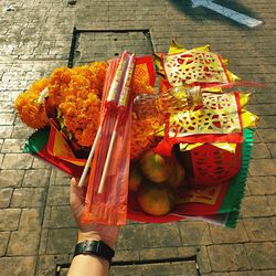 High angle view of person holding food on footpath