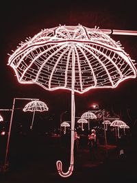 Illuminated ferris wheel at night