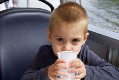 Portrait of boy drinking coffee