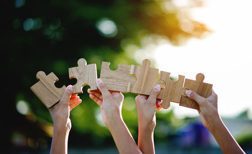 Cropped hand holding jigsaw pieces