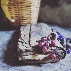 Close-up of purple flowering plant in basket on table