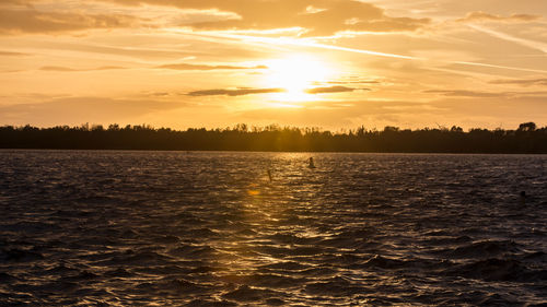 Scenic view of lake against sky during sunset