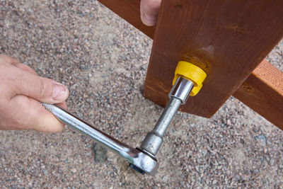 Cropped hand of man working on wood