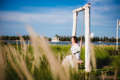 Woman standing on field against sky