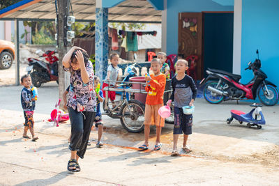 Rear view of people walking on zebra crossing