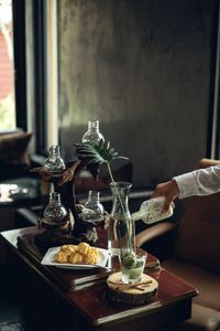 Cropped image of man making drink on table