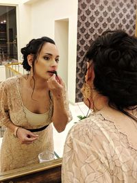 Portrait of woman with reflection at home