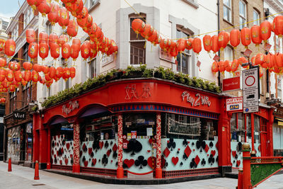 Illuminated lanterns hanging by building