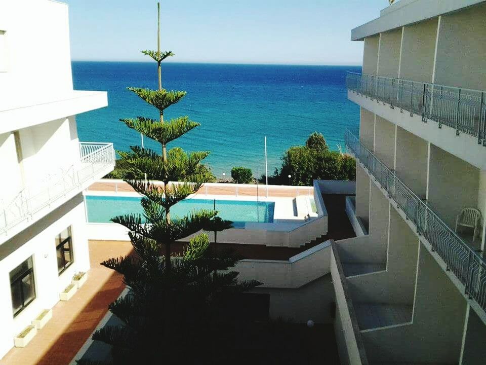 SWIMMING POOL BY SEA AGAINST SKY