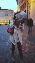 Woman walking on sidewalk