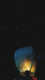 Illuminated lantern against sky at night