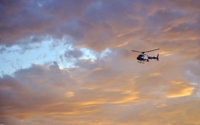 Low angle view of helicopter against sky