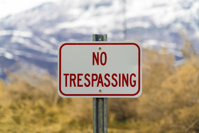 Close-up of road sign against blurred background