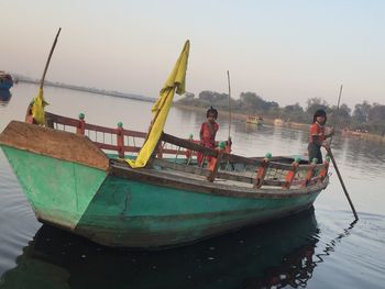 Boats moored in sea against sky