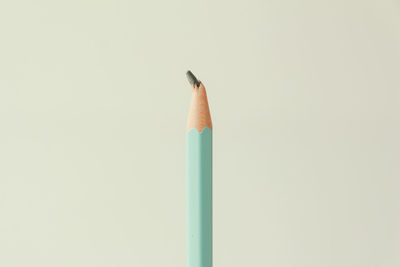 Close-up of colored pencils against white background