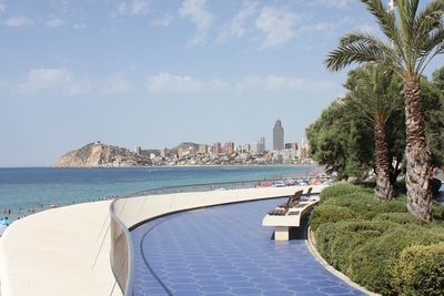 View of swimming pool by sea against sky