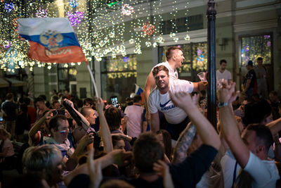 Group of people enjoying in city at night