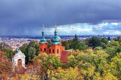 Panoramic view of trees and buildings against sky