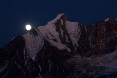 Low angle view of rock formation against clear sky at night