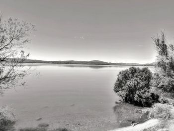 Scenic view of lake against sky during winter