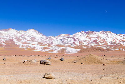 Scenic view of mountains against clear blue sky