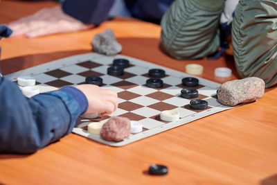 Midsection of man playing chess