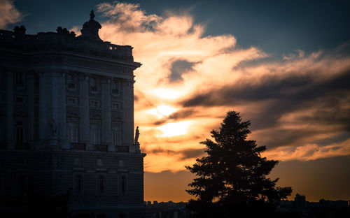 Low angle view of silhouette building against sky during sunset