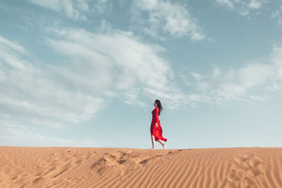 Side view of woman walking in desert