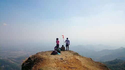 Rear view of friends on cliff