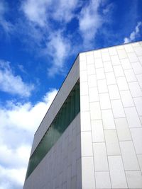 Low angle view of building against cloudy sky