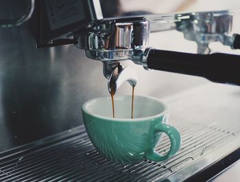 Espresso machine pouring coffee in cup