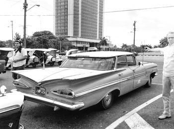 Vehicles on road by buildings in city