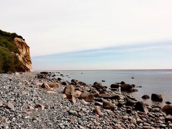 Rocks on beach against sky