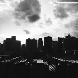 View of cityscape against cloudy sky