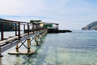 Pier over sea against sky