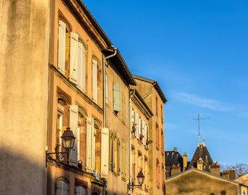 Low angle view of buildings against sky in city