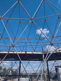 Low angle view of bridge against blue sky