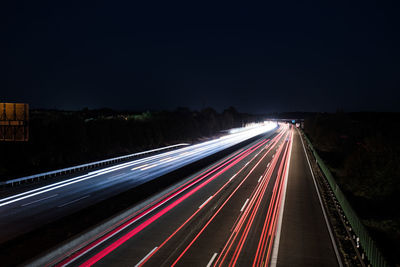 High angle view of light trails on highway at night