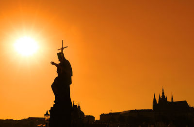 Low angle view of silhouette john the baptist statue against clear sky during sunset