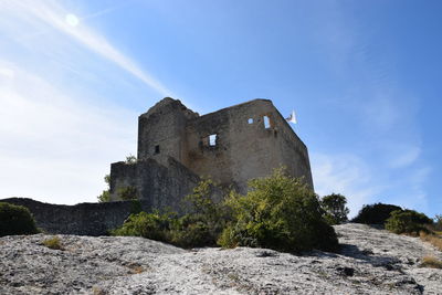 Low angle view of historic building against blue sky