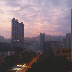 Aerial view of city lit up at sunset