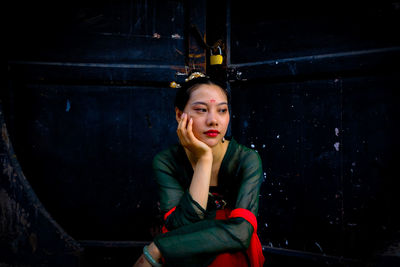 Portrait of beautiful young woman looking away