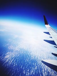 Aerial view of airplane wing over sea