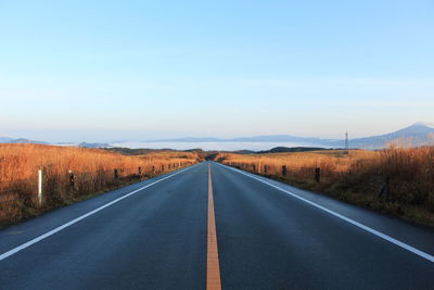 Empty country road against clear sky